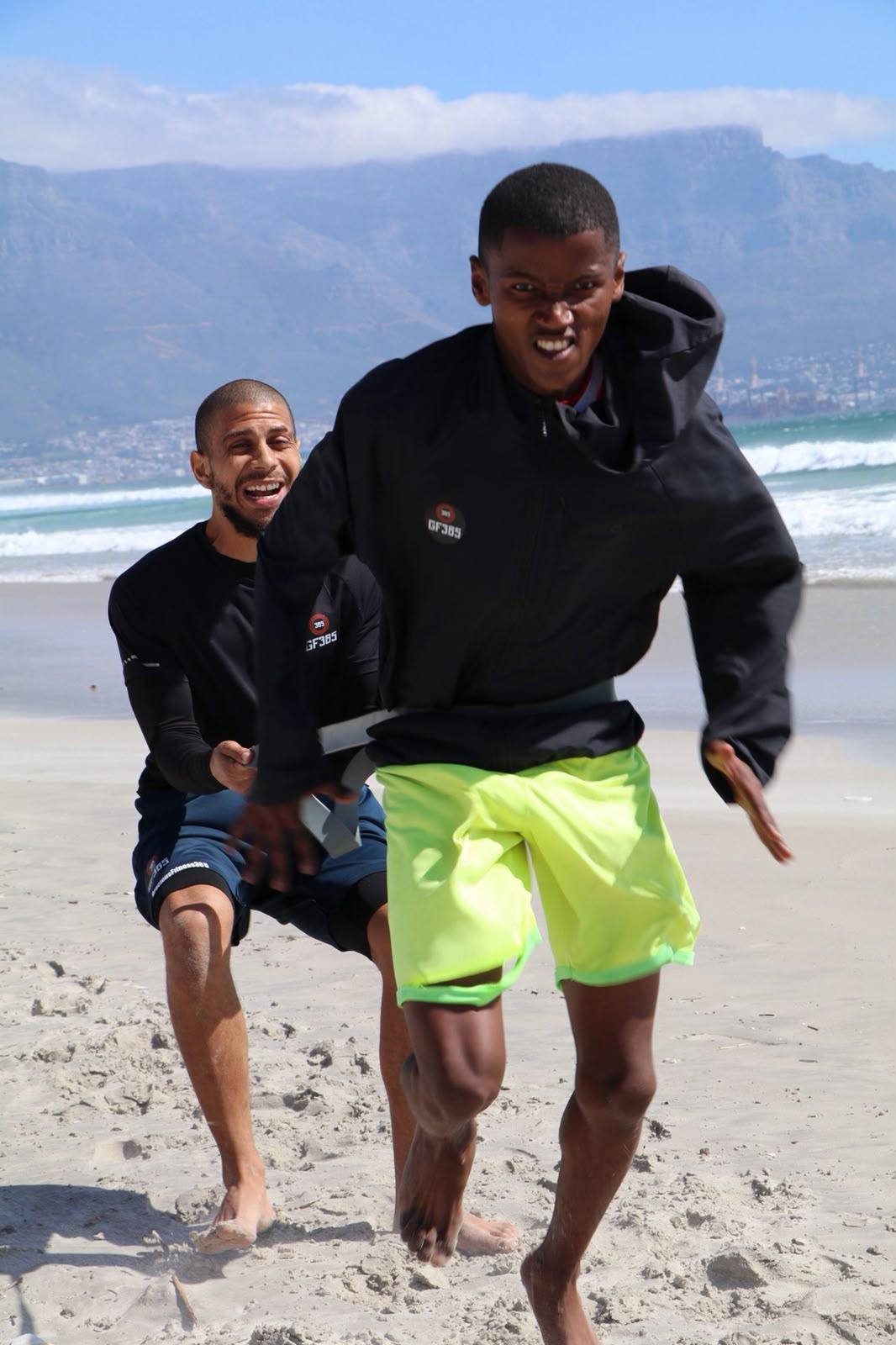 Athlete driving forward against a resistance band