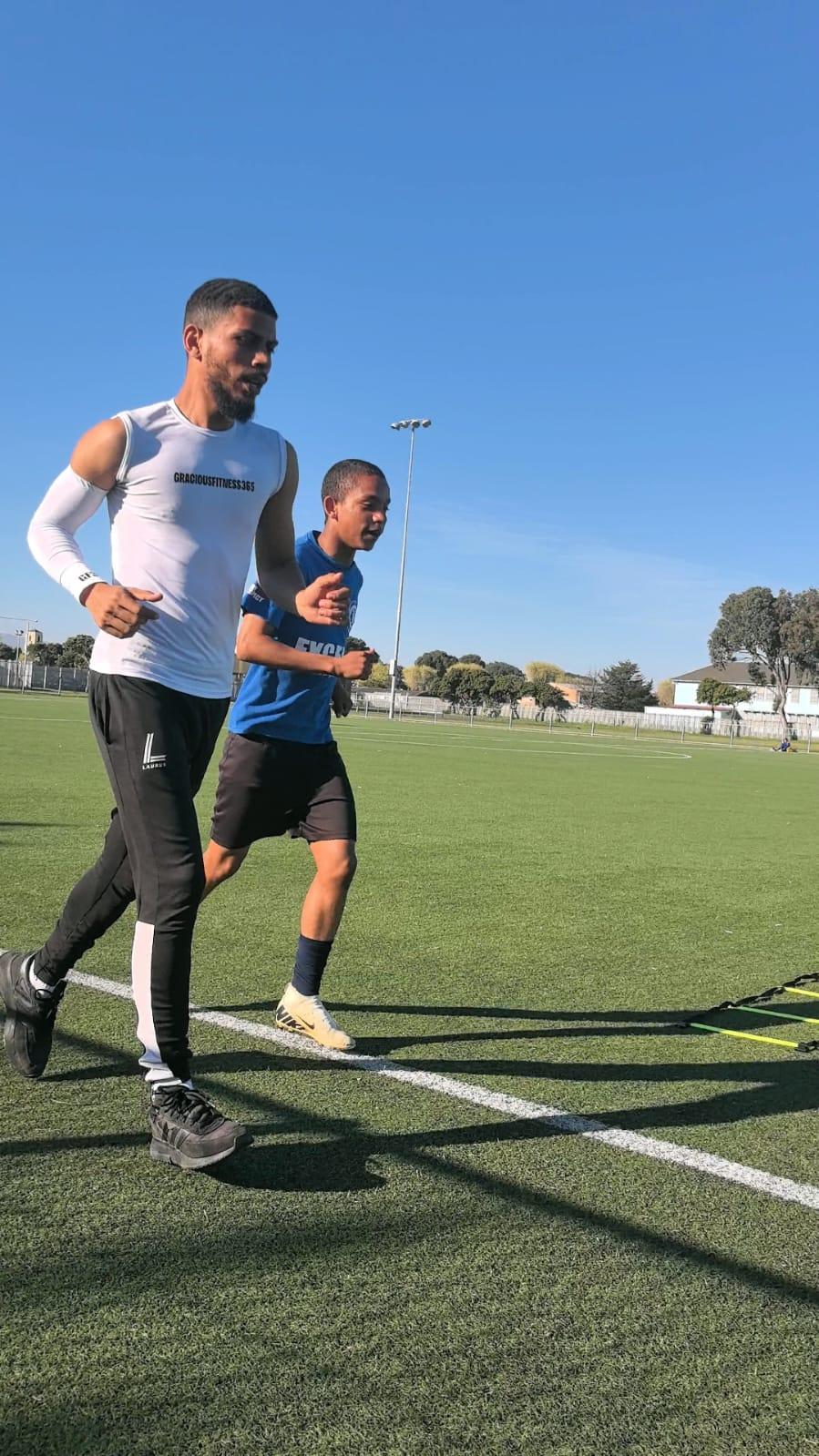 Coach running stride-for-stride with an athlete