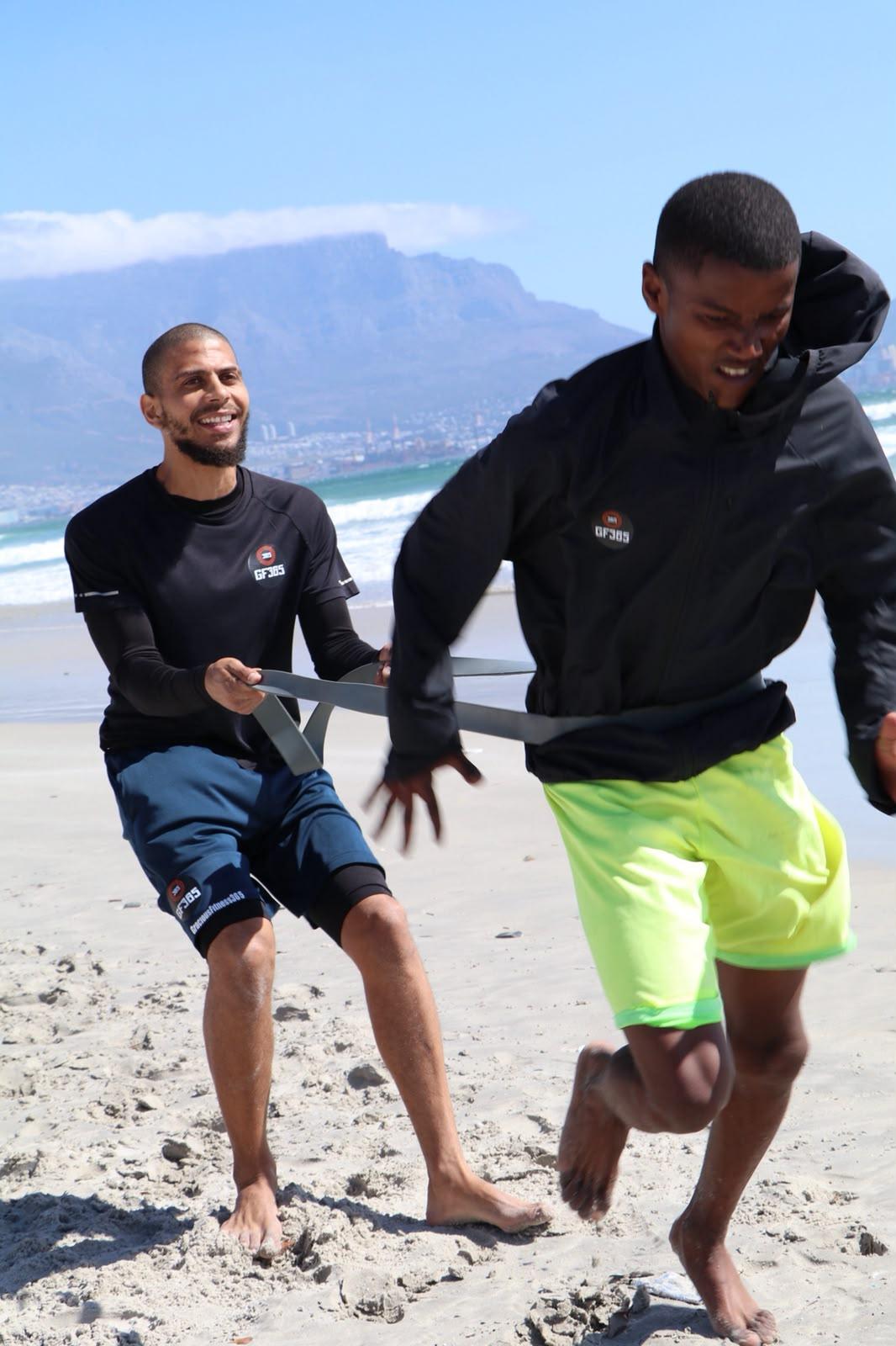 Resisted sprint with a band on the beach